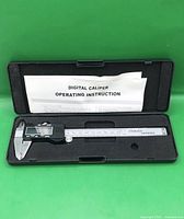 Caliper inside open storage case with instruction sheet