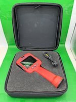 handheld display unit, cable and foam in open carry case