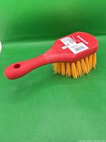 Side view of brush showing handle, bristles, size