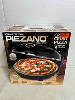 Front of box showing product name and image of pizza oven