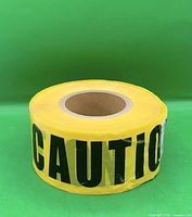 Front view of full roll showing yellow color and black CAUTION lettering