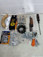 All items arranged showing tools, fasteners, wire, cable ties, hooks and strap
