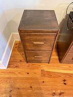 Front and top view of medium brown two-drawer wooden cabinet showing overall design