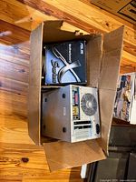 Cardboard box containing slim desktop tower and ASUS X Series motherboard box