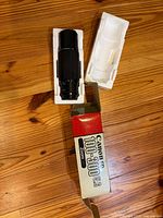 Lens in foam tray beside box lid