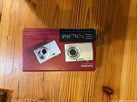 Camera placed on top of retail box showing model and brand