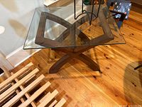 Overhead view showing glass top and X-shaped wood base