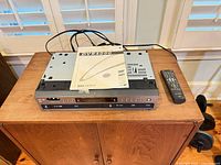 Front view of DVR4000 unit with manual on top and remote beside