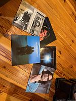 All five LP jackets fanned on floor showing front artwork