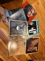 All six record sleeves fanned out on wooden surface