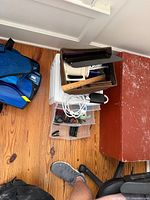 Overhead view showing wood crate, letter tray, ruler, telephone, cords in drawers