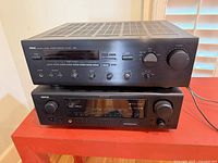 Stacked Yamaha and Denon receivers front view