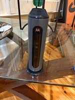 Front three-quarter view of Motorola tower modem showing LED panel and logo