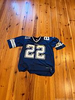 Full view of front of navy blue Cowboys #22 jersey
