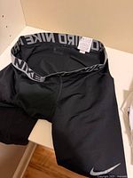 Black Nike Pro compression shorts showing waistband branding and swoosh logo