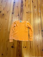 Full view front of orange waffle knit top