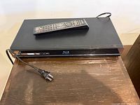 Top view of Samsung Blu-ray player with remote and power cord