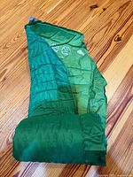 Pacific Outdoor pad partially unrolled with rolled section at base, valve visible, adhesive blemish spot