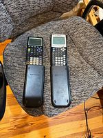 Both calculators with covers on chair