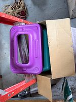 Open box with purple riser and teal platform visible