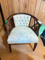 Front view of wood armchair showing upholstery and frame