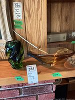 Amber art glass bowl and green art glass vase displayed together