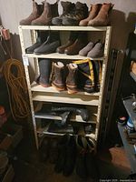 shelving unit with multiple pairs of boots and shoes