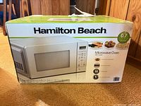 Front of sealed box showing Hamilton Beach 0.7 cu ft 700-Watt microwave oven