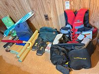 All items laid out together including lifejacket, bags, mats, umbrellas, sandals