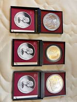 All three cased Montreal 1976 Olympic coins displayed open