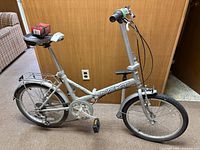 Side view of Next folding bike with accessories on saddle