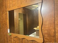 Front view of rectangular wood framed mirror