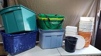 Overall view of totes and buckets on table
