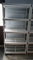Full view of the 5-tier white plastic shelving unit