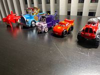 All five toy vehicles lined up on table