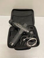 Massage gun and accessories inside carrying case