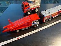 All three toy trucks side by side showing overall condition and scale