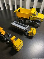 Group shot of Tonka dump truck, Truck 28 dump body, construction hauler with crane and extra cab