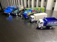 All seven toy vehicles lined up on tabletop