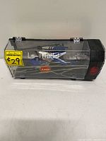 Helicopter inside clear storage/charging case, front view