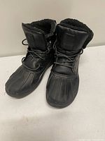 Full view of both black Nautica duck boots, side-by-side