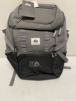 Full front view of grey/black Projekt Karson Pack backpack with tags attached