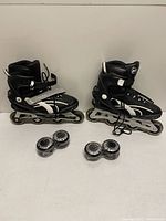 Pair of Ultra Wheels inline skates, two sealed packs of Rollerblade wheels
