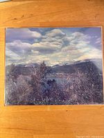 Front view of framed photograph showing mountainous landscape under cloudy sky