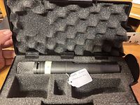 Microphone seated in foam inside the AKG case