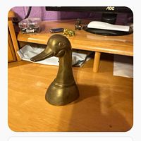 front view of brass duck head bookend