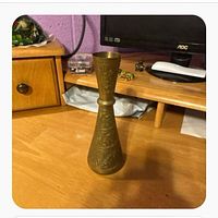Full view of brass vase on desk