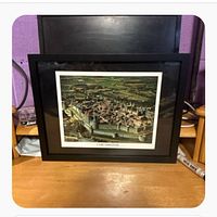 Front view of framed Carcassonne print on table