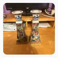 Front view of both square-tapered Famille Rose porcelain candlesticks