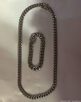 Necklace and bracelet laid flat showing full length and matching link style